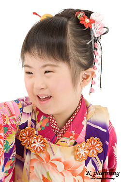 写真：ピンクや紫、色鮮やかな和服を身に付け、笑顔で写っている女の子